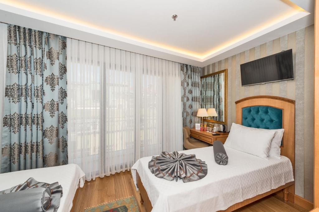 Postel nebo postele na pokoji v ubytování Aprilis Gold Hotel - Special Category