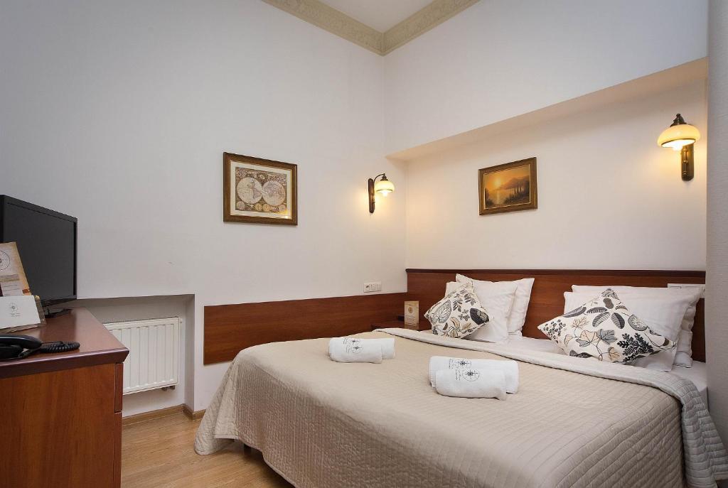 a bedroom with a bed with two towels on it at Ventus Rosa Apartments in Krakow
