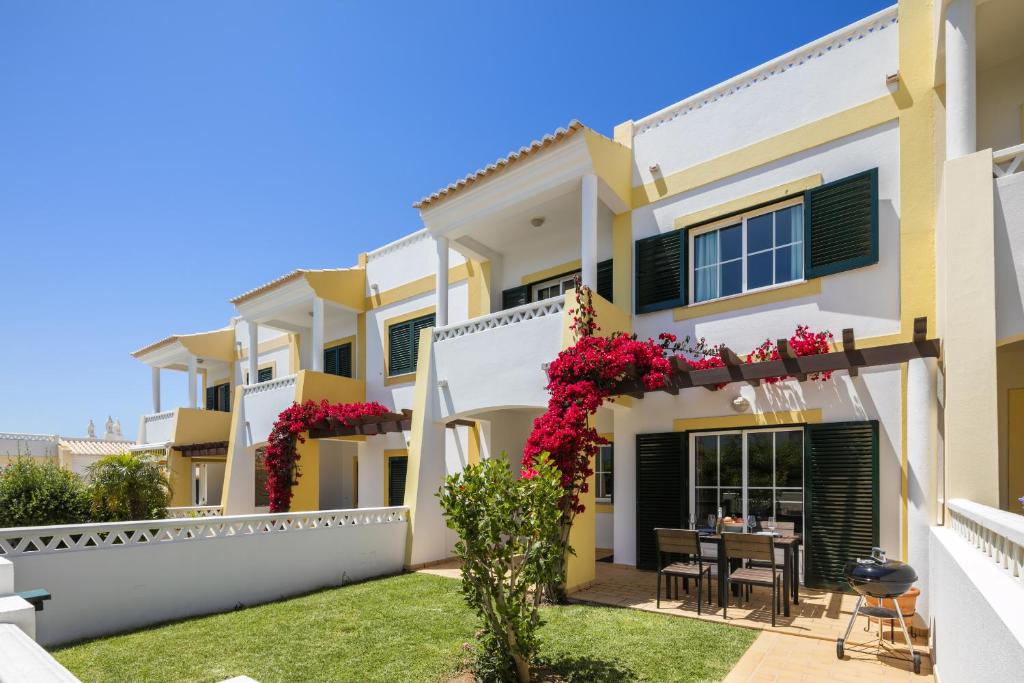 a villa with a garden in front of it at Terraços de Benagil 23 (Casa Alvorada) in Benagil