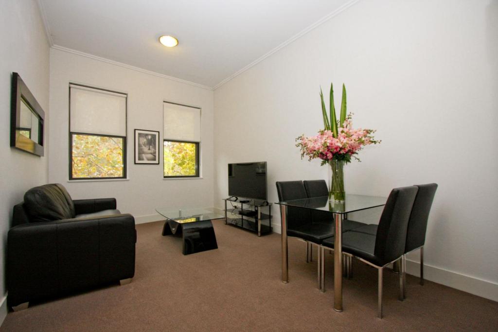 a living room filled with furniture and a tv at The Star Apartments in Newcastle