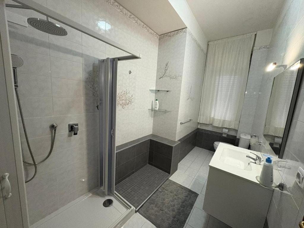 a bathroom with a shower and a sink at Stefano's house in Siracusa