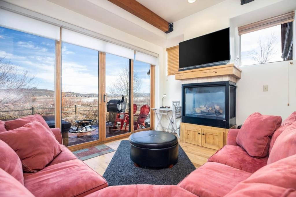 a living room with two red couches and a flat screen tv at Mountain Retreat Hot Tub Views,Near Shops in Park City