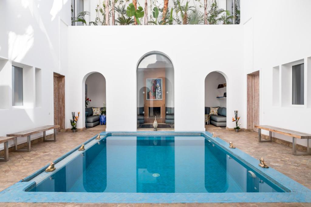a pool in the middle of a building at Riad Zyo in Rabat