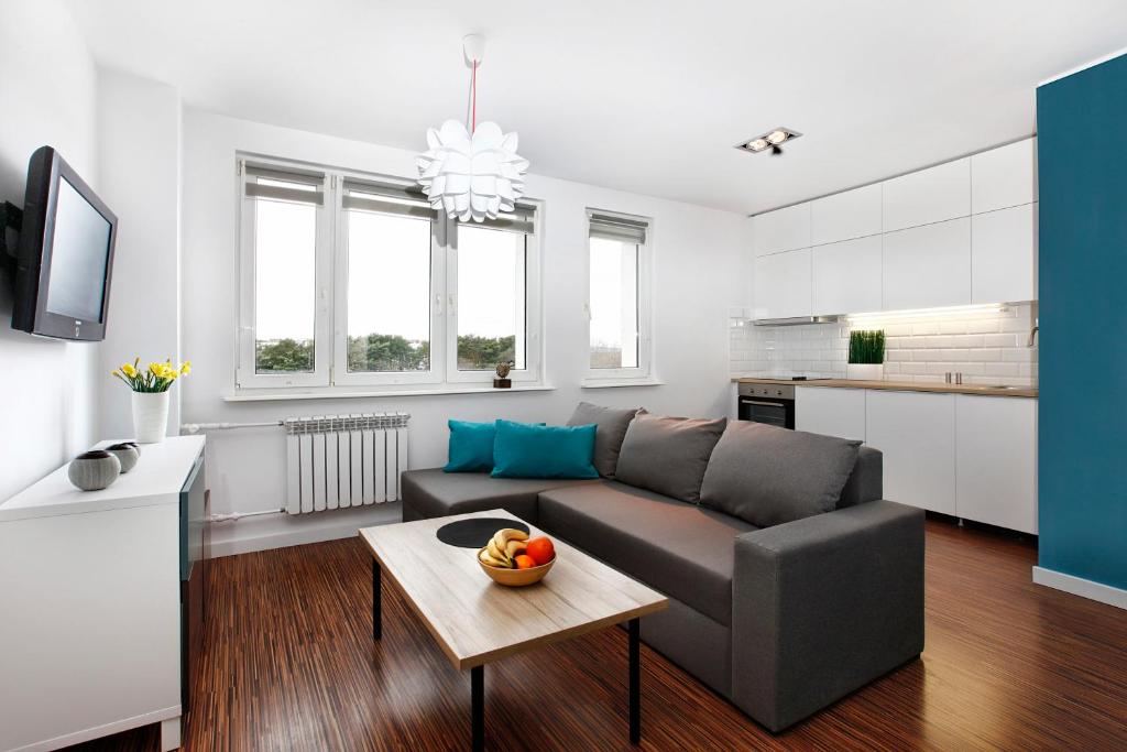 a living room with a couch and a table at Apartament Blisko Morza Gdańsk in Gdańsk