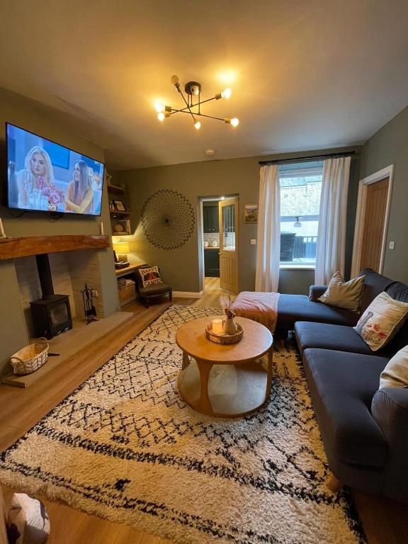 a living room with a couch and a table at Nala's Nest in Hexham