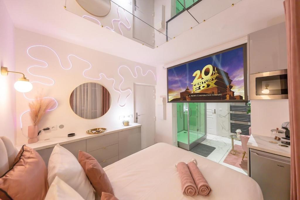 a living room with a bed and a large window at Suite Hammam Love Luxe paisible in Les Pavillons-sous-Bois