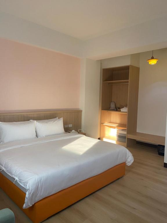 Postel nebo postele na pokoji v ubytování Orange Homestay