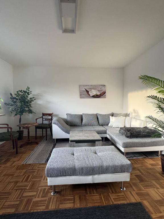 a living room with a couch and a table at Gemütliche Ostsee Oase, 3 Zimmer mit Balkon in Bad Schwartau in Bad Schwartau
