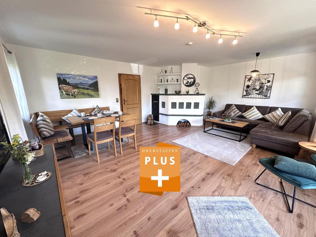 a living room with a couch and a dining room at Ferienwohnung Heidi mit Oberstaufen PLUS in Oberstaufen