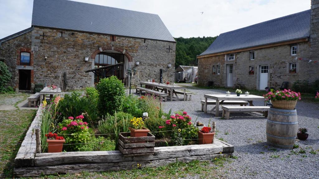 a garden with flowers in front of a building at La Ferme de Werpin in Hotton