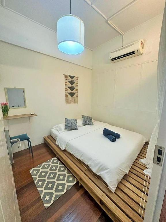 a bedroom with a large bed with a blue light at Jonker Vibe Inn in Malacca
