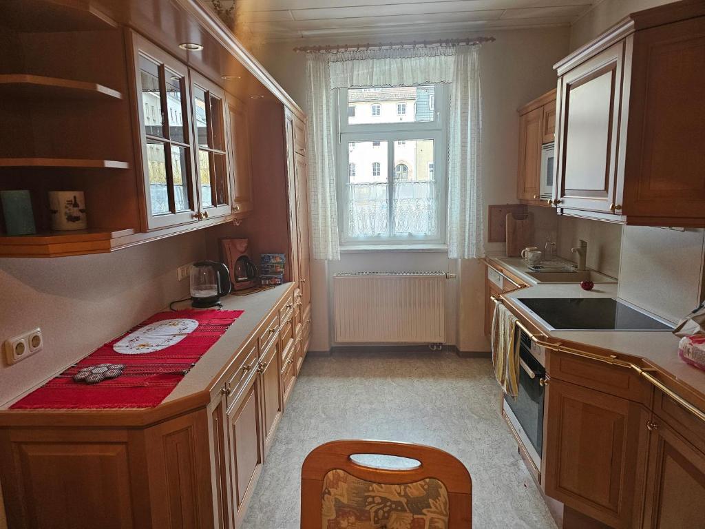 a kitchen with wooden cabinets and a sink and a window at Unterkunft für Familien, Montagen arbeiter, und und und, Sweet Home in Roßwein