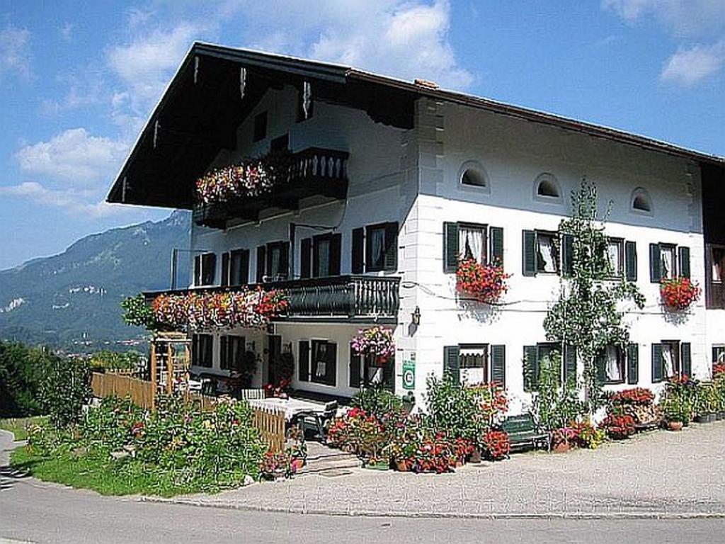 a large white building with lots of plants on it at Berghof Moar in Unterwössen