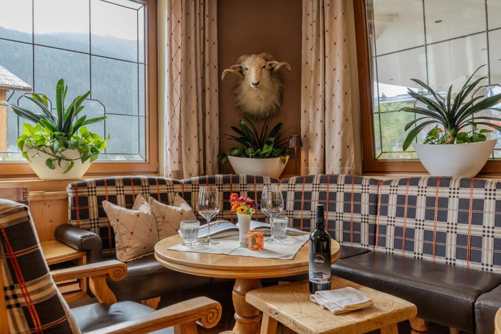 a living room with a couch and a table at Hotel Neuwirt in Brandenberg