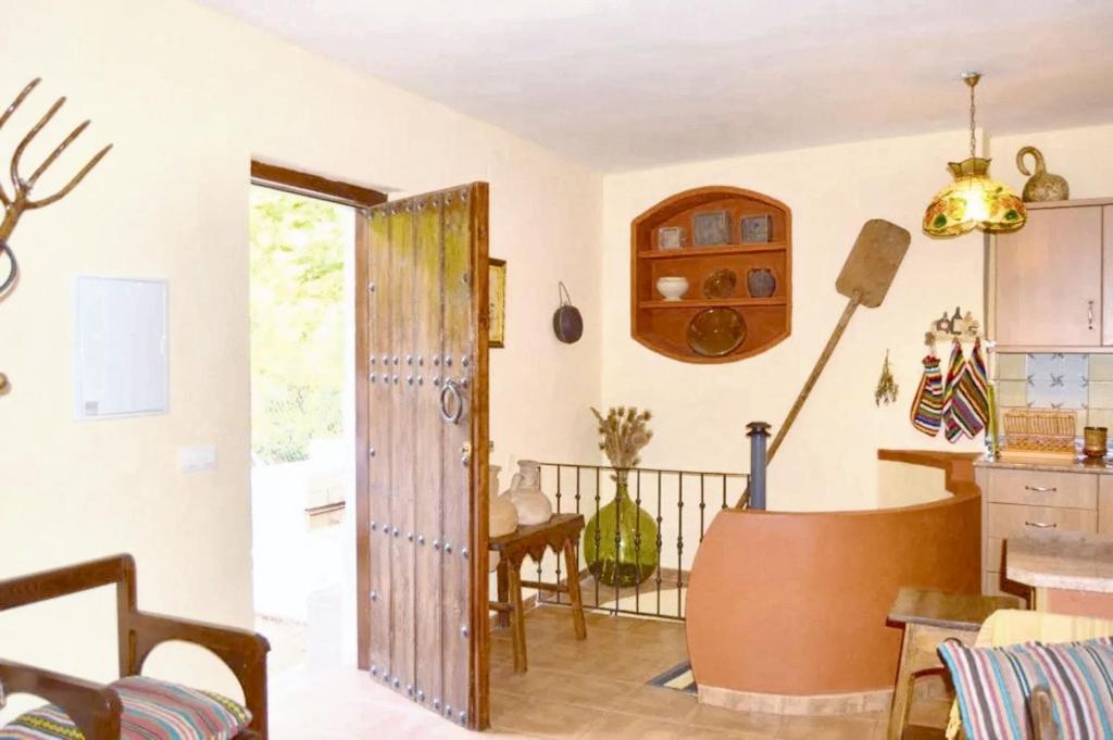 a kitchen with a door open to a dining room at Charming house with mountain view in Siles + Garden in Siles