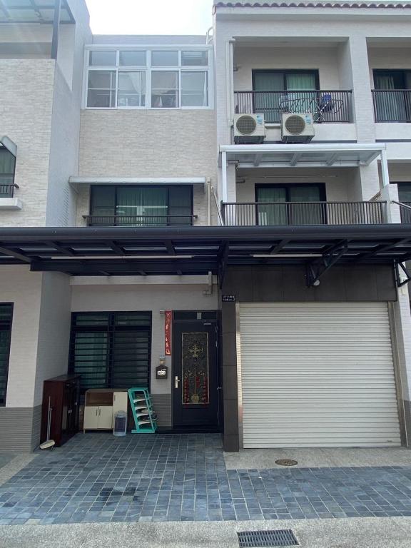 an apartment building with a garage and a door at 鴻源雅居 in Shanhua