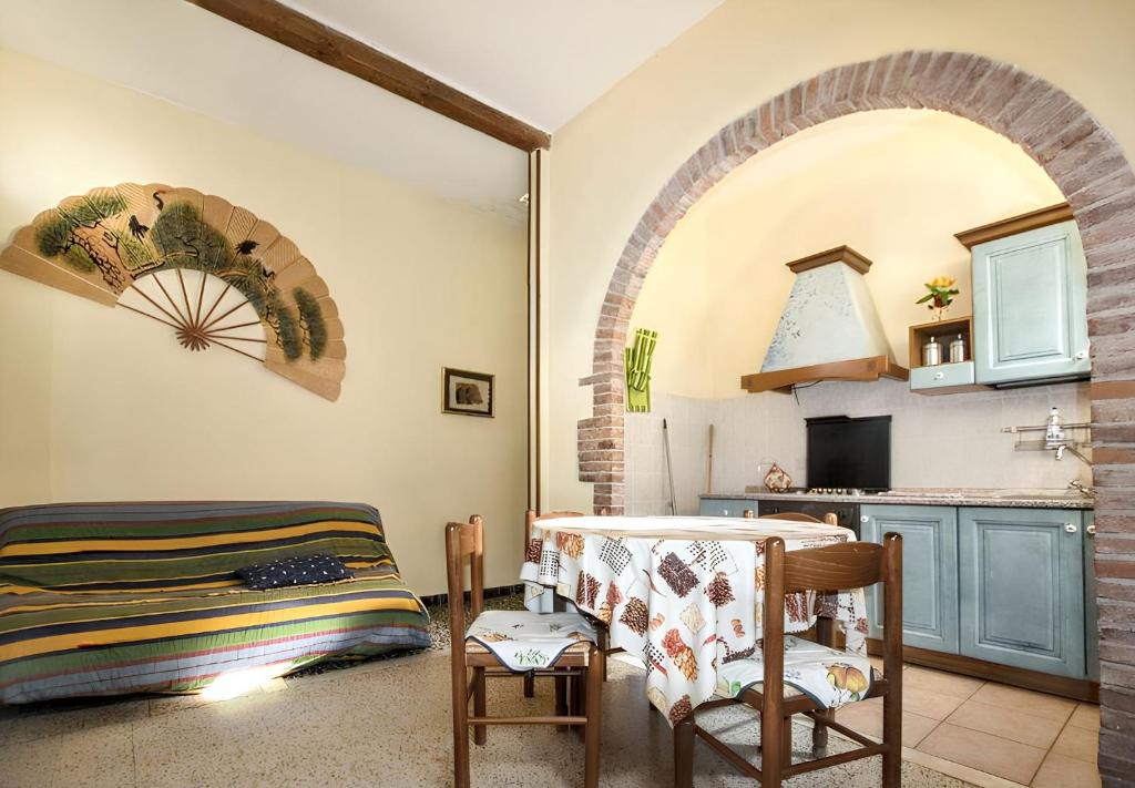 a living room with an archway and a kitchen at Charming Apartment in Massa Marittima, Shared Pool in Massa Marittima