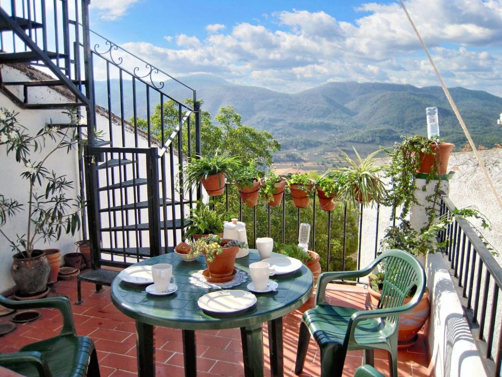 a table and chairs on a balcony with a view at Spacious House in Hornos with Mountain View in Hornos