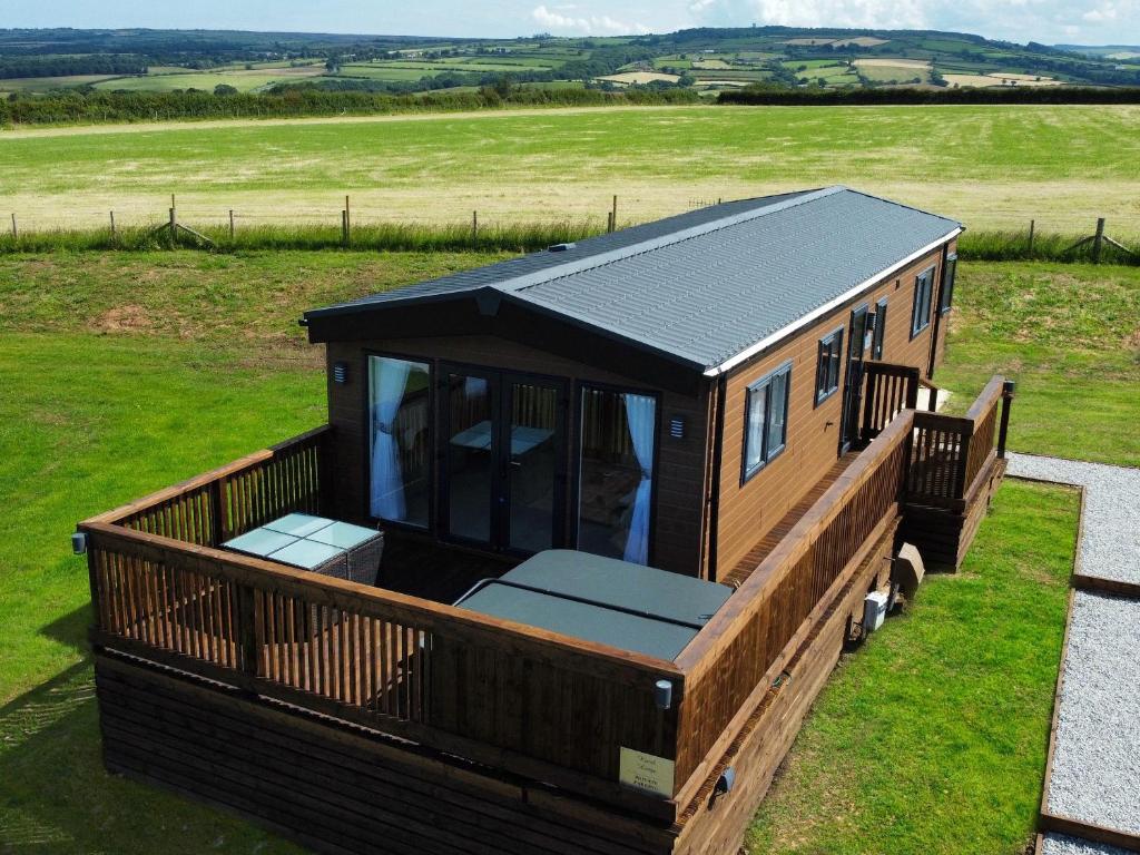 a tiny house on a trailer in a field at Hazel Lodge in Whitby