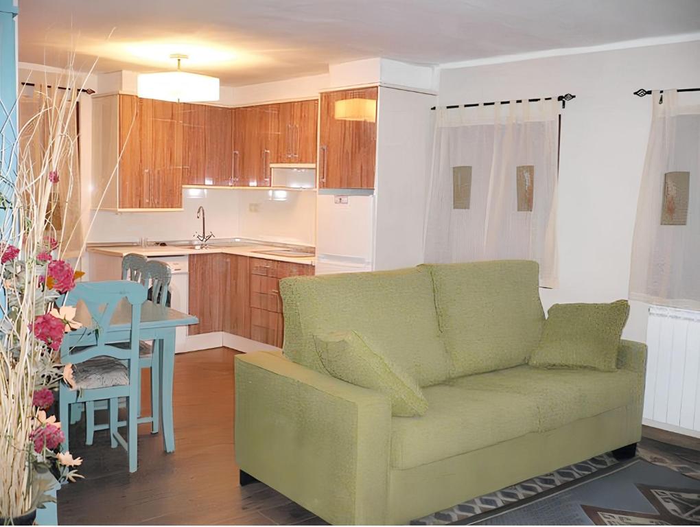 a living room with a couch and a kitchen at Comfortable Apartment with Mountain View in Laspaúles in Laspaúles
