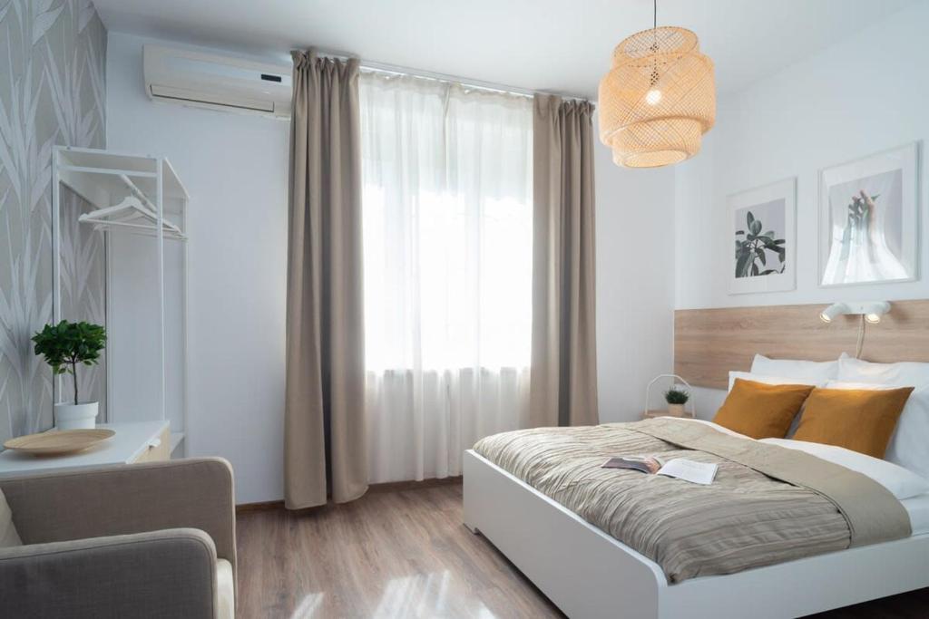 Un dormitorio con una cama y un escritorio y una ventana. en Stylish apartment under the Buda castle, en Budapest