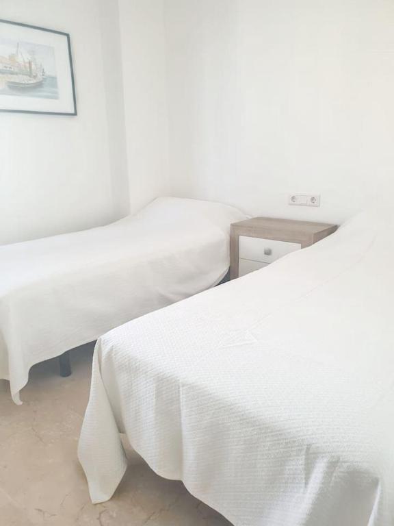 A bed or beds in a room at Spacious Apartment with Sea View in Estepona - 140 m²