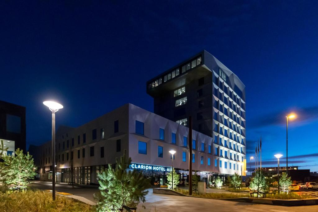 a building at night with lights on at Clarion Hotel Air in Sola