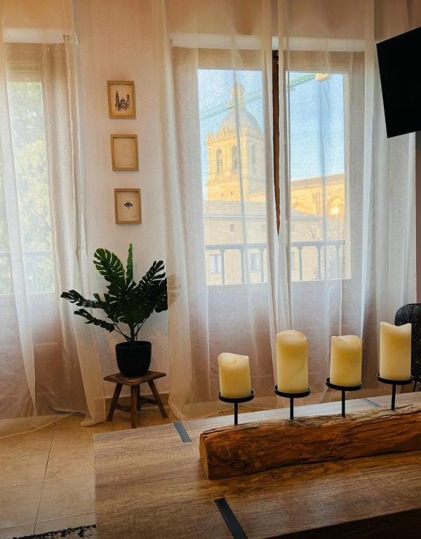 a room with a table with candles and a window at Piso Espectaculares Vistas in Ciudad-Rodrigo