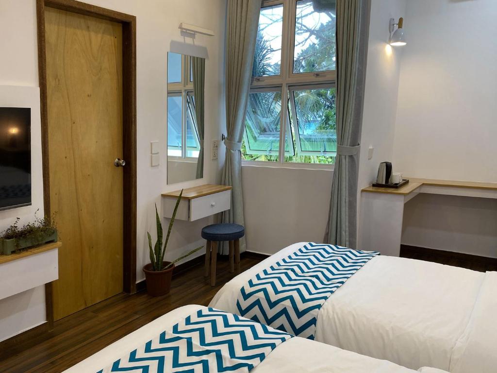 Postel nebo postele na pokoji v ubytování Calm Beach Inn