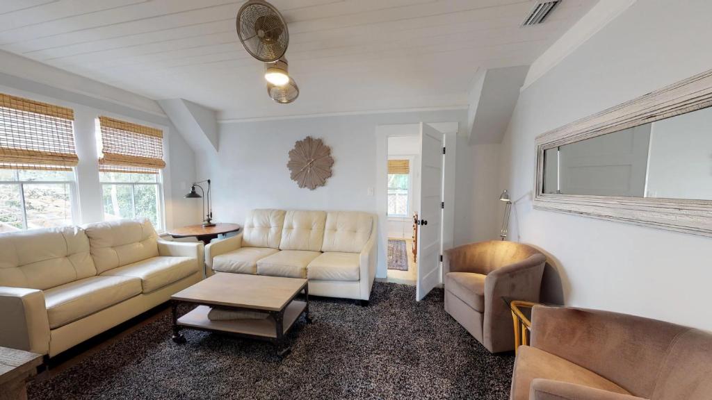 a living room with two couches and a table at Renovated Lemon Guesthouse 4 KING Bedrooms Downtown Half Mile Stroll- Beach Only 3 Miles in Saint Augustine