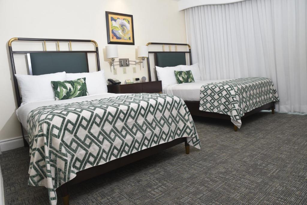Postel nebo postele na pokoji v ubytování Courtleigh Hotel & Suites