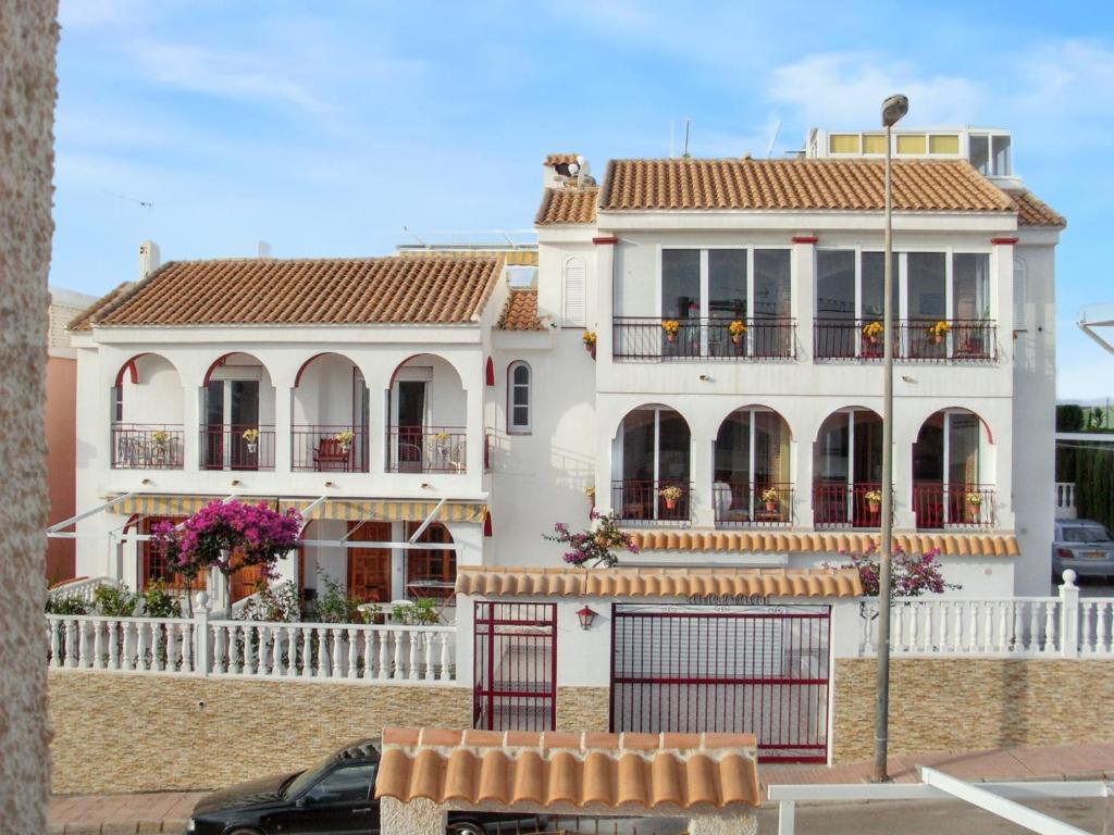 a white house with a fence in front of it at Welcoming apartment in Mazarrón 56 m² with shared poolmo in Mazarrón