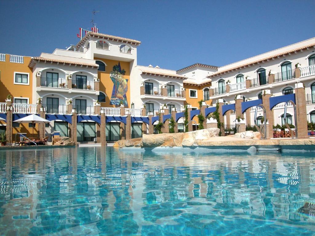 a swimming pool in front of a hotel at Hotel La Laguna Spa & Golf in Torrevieja
