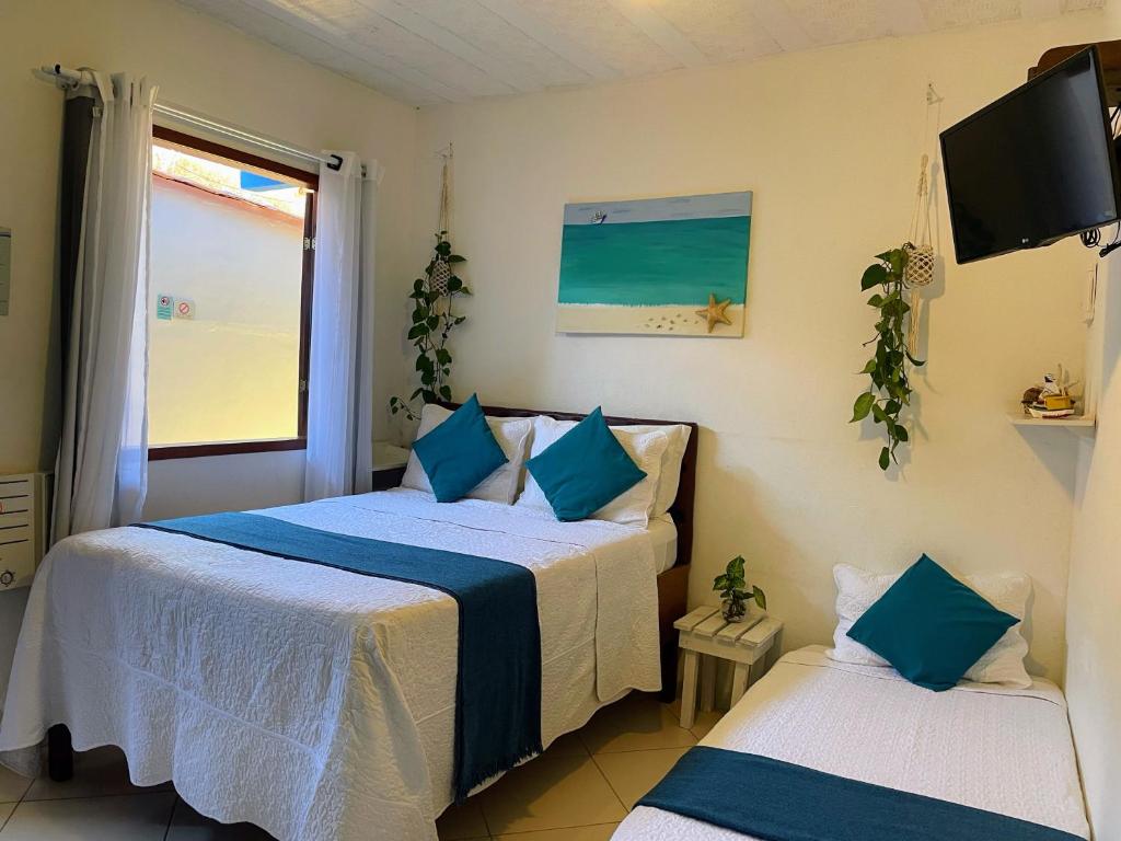 Postel nebo postele na pokoji v ubytování Suites Casa Azul-Vila do Abraão- conforto, limpeza, ótima localização