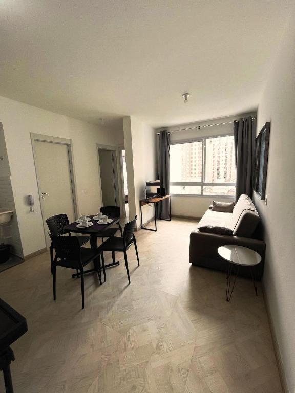 a living room with a couch and a table at LK Centro 3 in Belo Horizonte