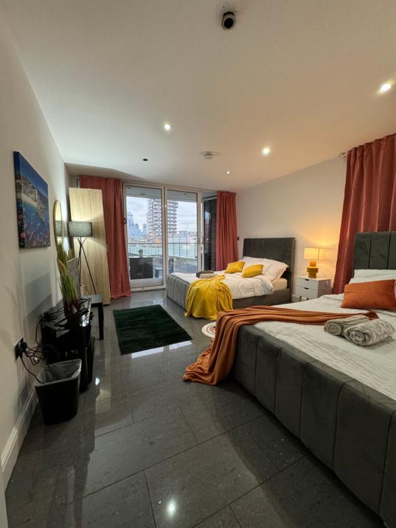 a hotel room with two beds and a large window at Cosy Luxurious Room in The Heart of London in London