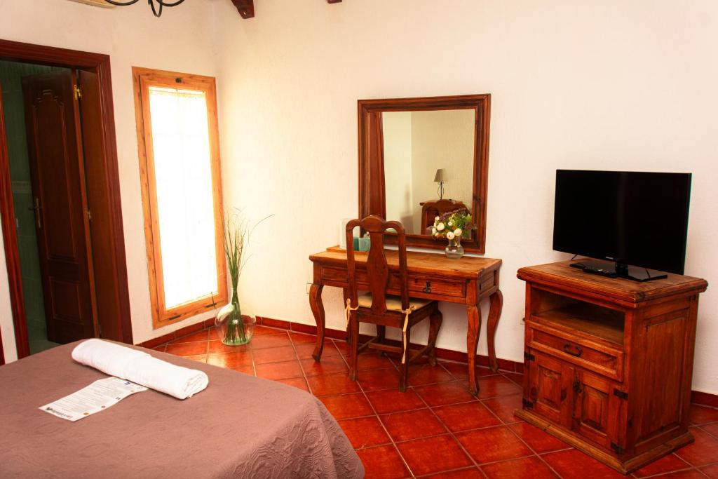 Televízia a/alebo spoločenská miestnosť v ubytovaní Hotel Las Cañadas