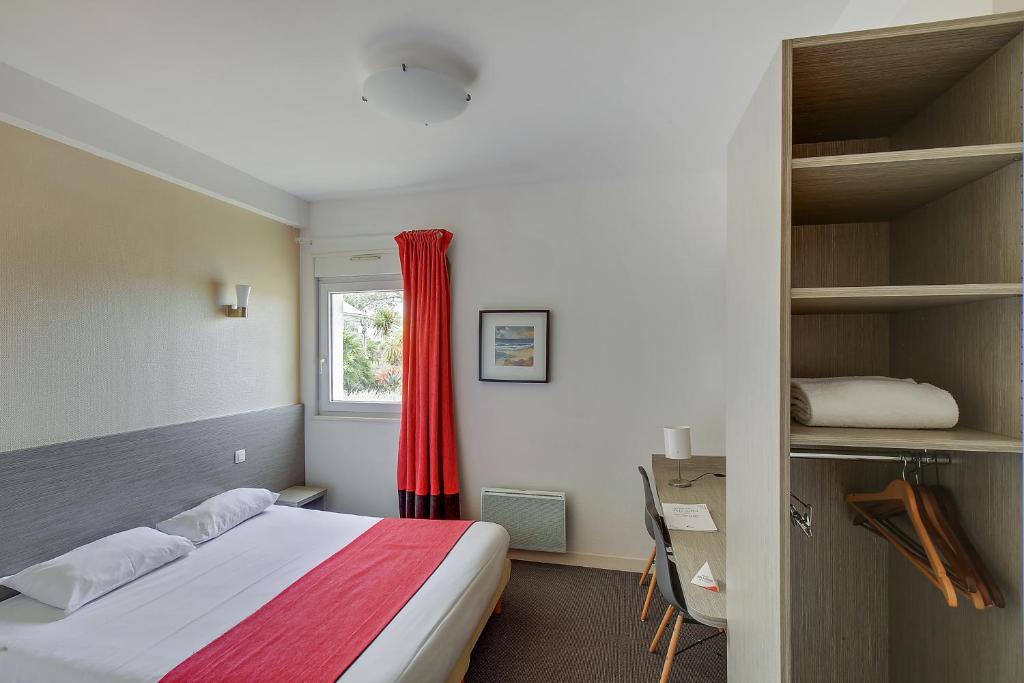 Postel nebo postele na pokoji v ubytování Hôtel Arcadia