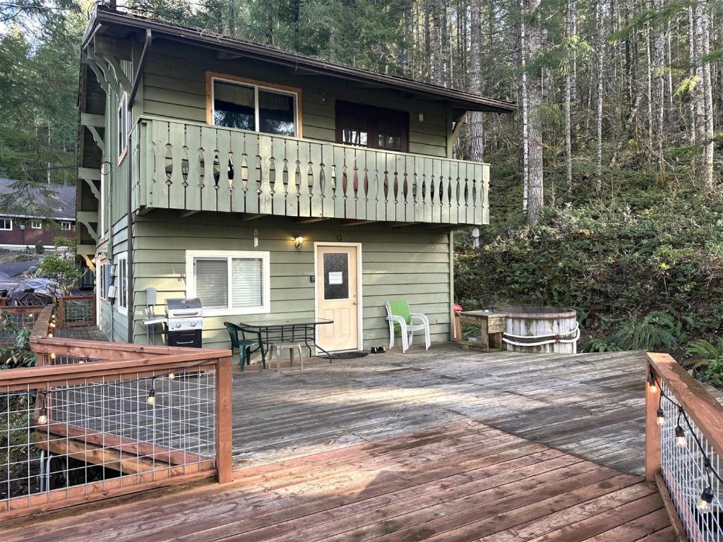a house with a deck and a patio at Culps Cascade | Wi-Fi, Woodstove, Cedar Hot tub in Packwood