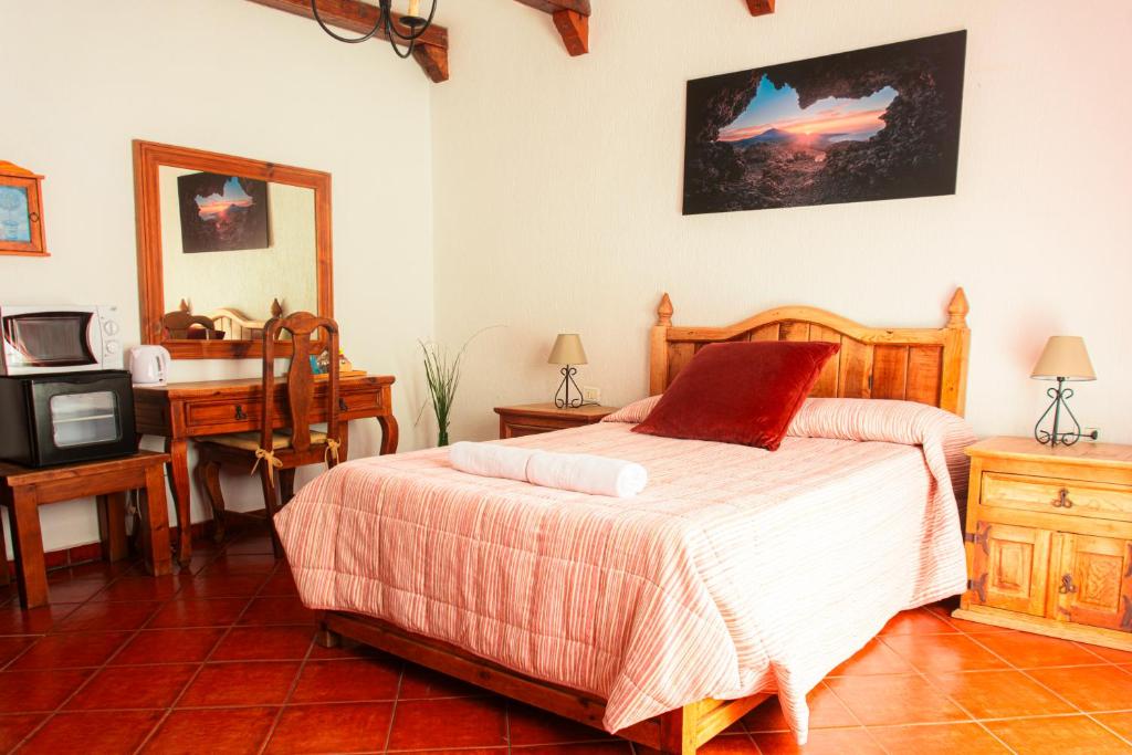 Posteľ alebo postele v izbe v ubytovaní Hotel Las Cañadas