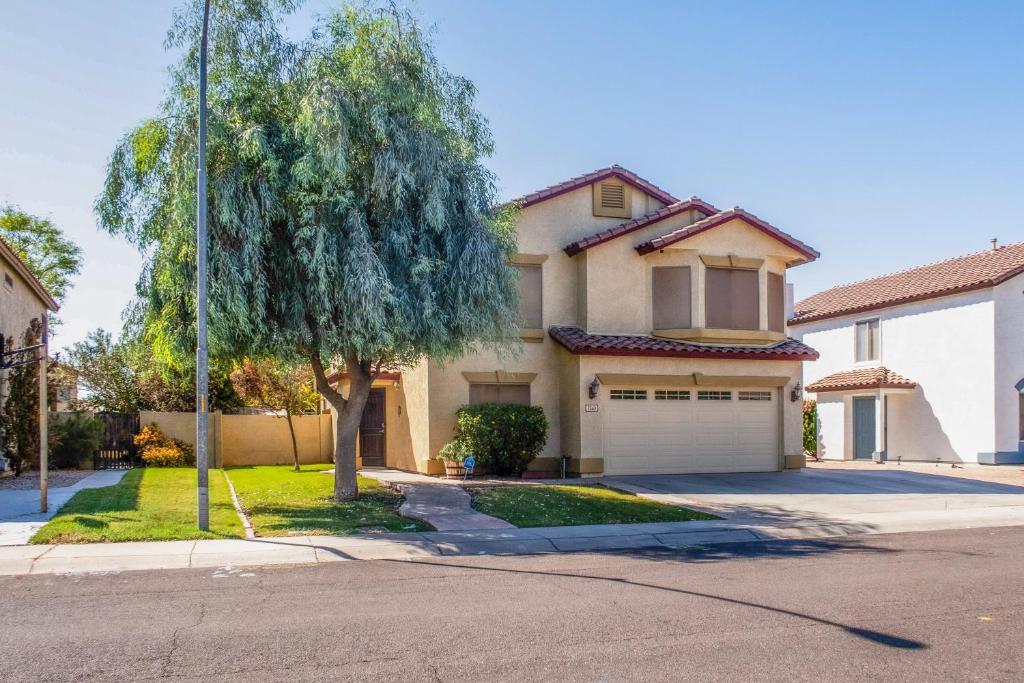 a house with a tree and a garage at Sunny Retreat in Glendale in Glendale