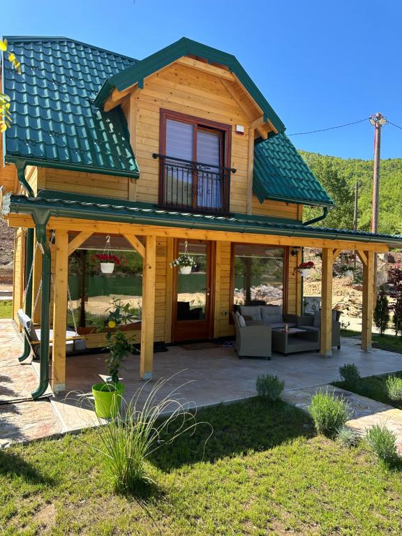 a large wooden house with a roof at Stara pruga Jaz 2 in Višegrad
