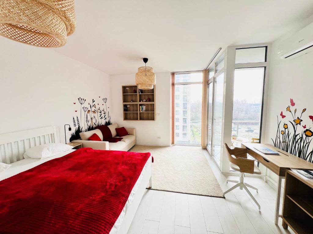 une chambre blanche avec un lit rouge et un bureau dans l'établissement One Apartments NordOne Iulius Town, à Timişoara