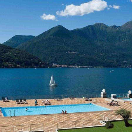 a swimming pool with a sail boat in the water at Italian Lake Getaway in Maccagno Superiore