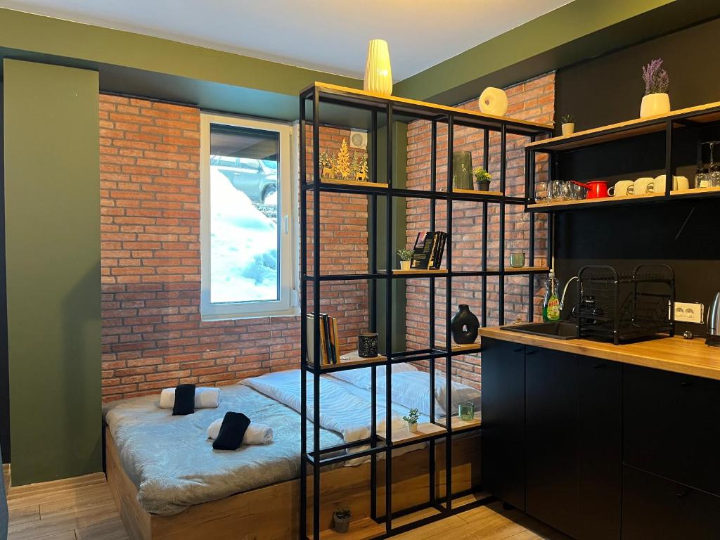 a room with a book shelf with a bed in it at Mickitos Cozy Studio Two in Mavrovo