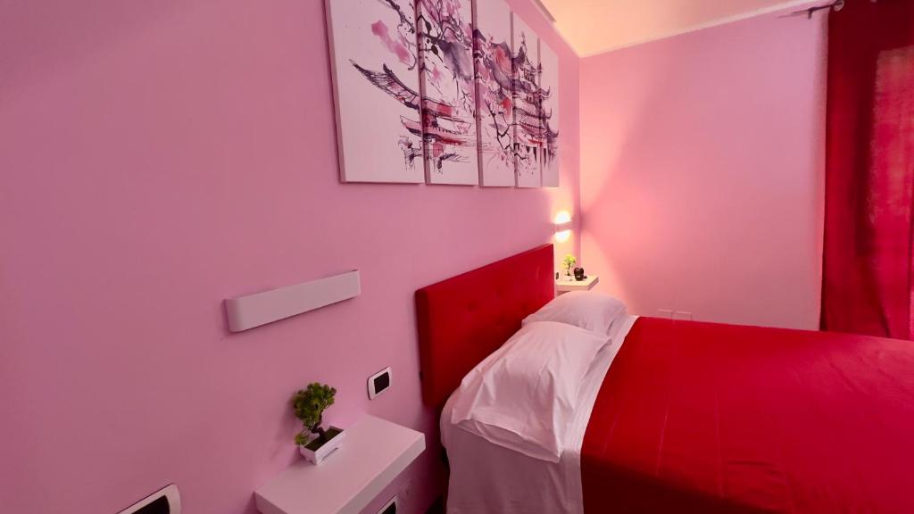 a bedroom with a red bed with a red headboard at B&B Villa Sabrina in Arezzo