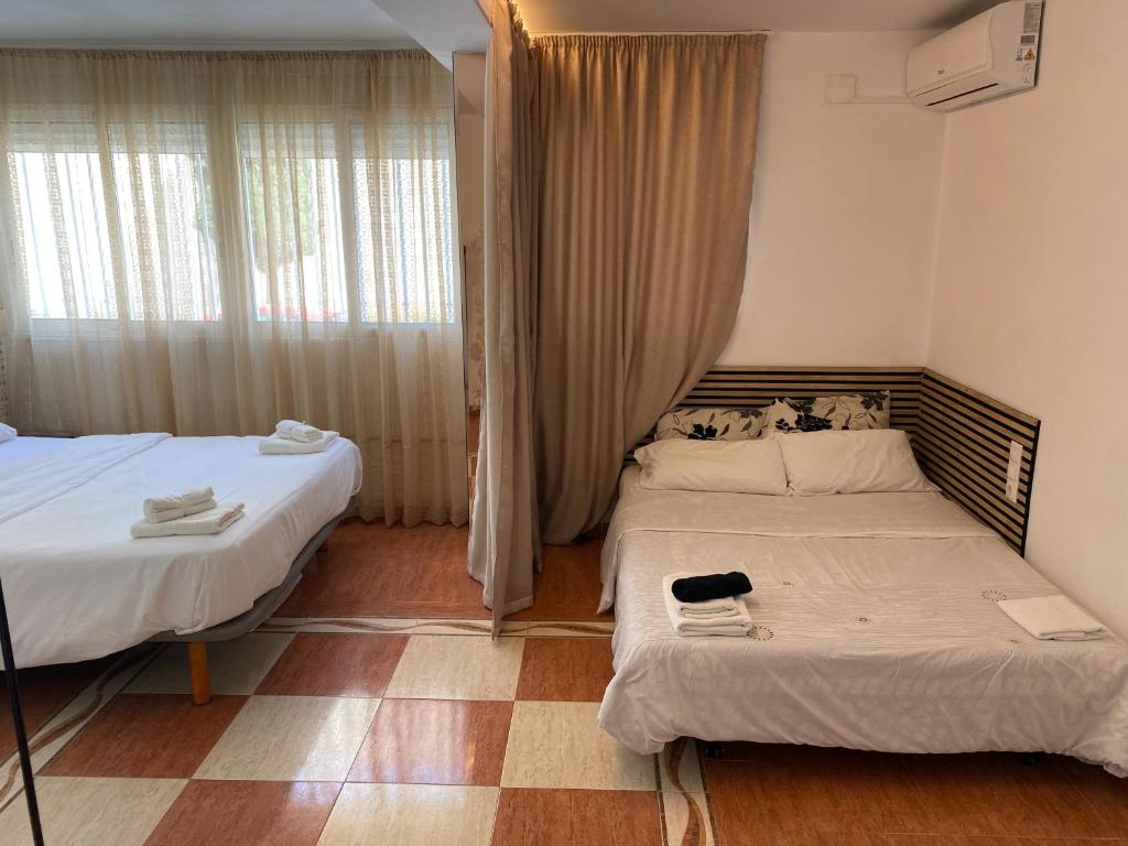 Postel nebo postele na pokoji v ubytování Habitaciones con baño y cocina privada