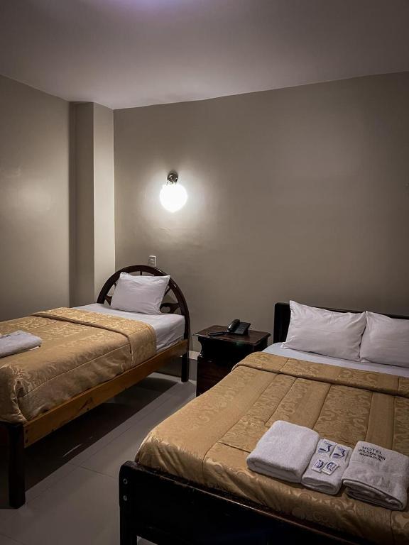 Postel nebo postele na pokoji v ubytování Hostal Wilson Inn