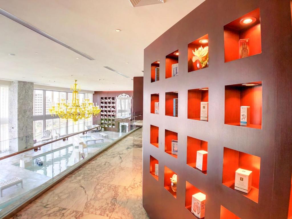 a large lobby with orange walls and a glass floor at Sky High Penthouse Corner 2BR 2BA Icon Brickell in Miami