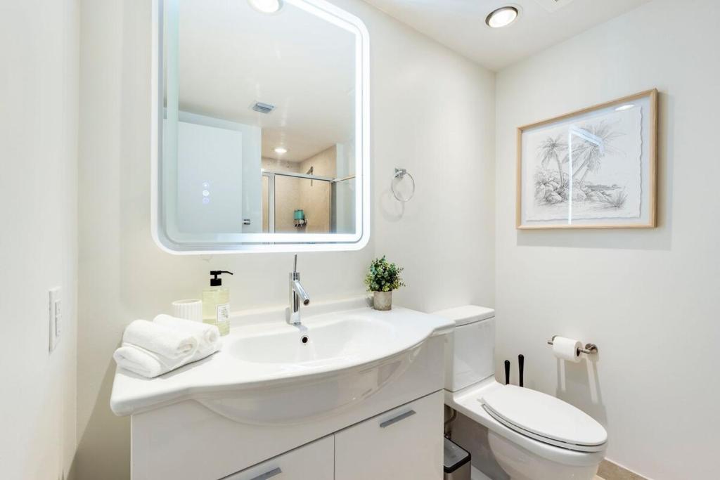 a white bathroom with a sink and a toilet at Sky High Penthouse Corner 2BR 2BA Icon Brickell in Miami